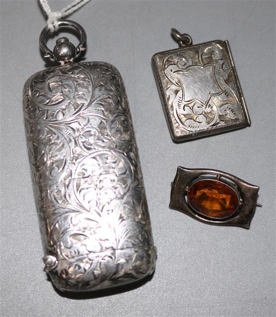 A silver combination vesta/sovereign case, a stamp case and brooch
